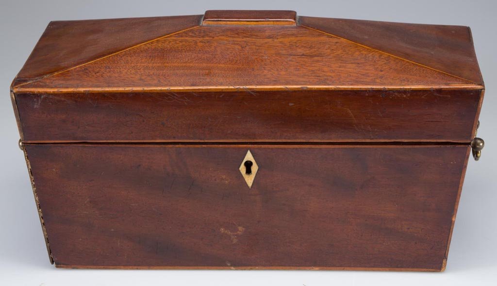 REGENCY MAHOGANY TEA CADDY: REGENCY MAHOGANY TEA CADDY, rectangular form with hinged lid, edge stringing, bone escutcheon, and brass bail handles, three-section divided interior with two lids. First half 19th century. 6" H, 11 3