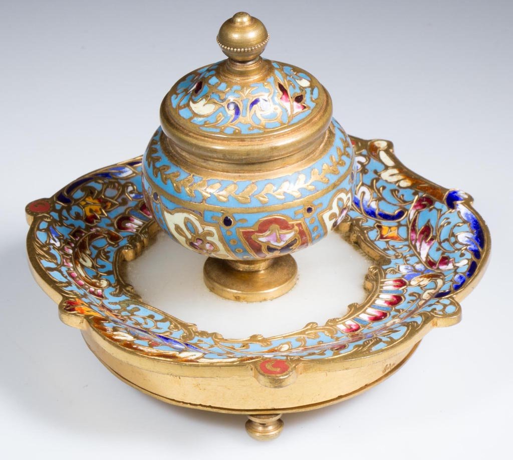 FRENCH DORE BRONZE, CHAMPLEVÉ ENAMEL AND MARBLE INKWELL: FRENCH DORE BRONZE, CHAMPLEVÉ ENAMEL AND MARBLE INKWELL, hinged lid, glass insert, raised on three feet. First quarter 20th century. 3" H, 4" D. Provenance: Property from a Private Canadian collectio