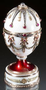 RUSSIAN 14K GOLD GUILLOCHE AND JEWEL ENCRUSTED EGG IN: RUSSIAN 14K GOLD GUILLOCHE AND JEWEL ENCRUSTED EGG IN THE MANNER OF CARL FABERGE, the body with applied three-color gold ribbon-tied swags and tassels set with rubies, rose-cut diamonds, seed pearls a