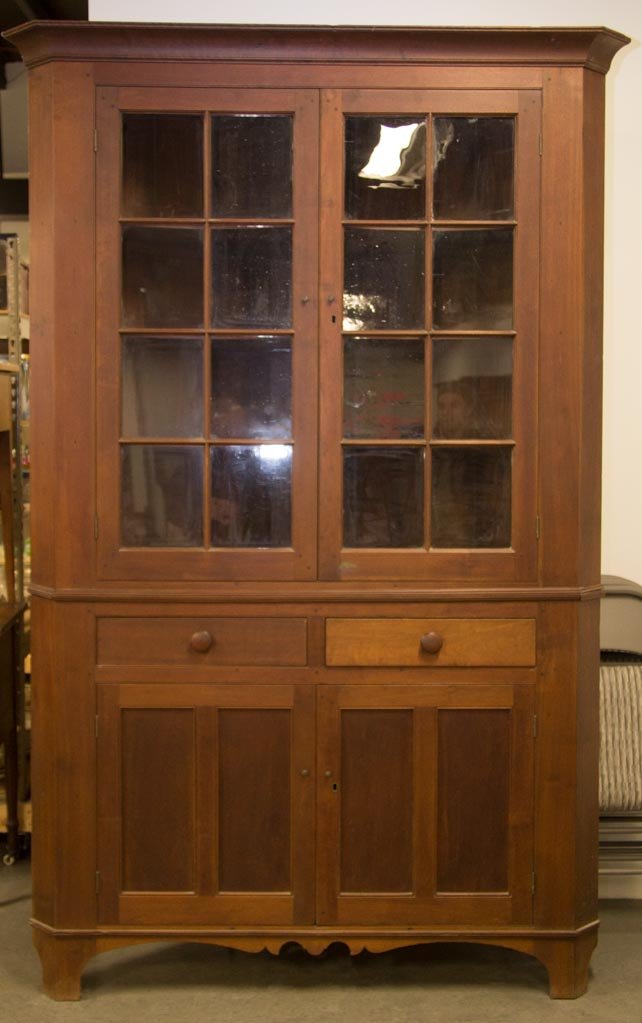 SHENANDOAH VALLEY OF VIRGINIA FEDERAL WALNUT CORNER: SHENANDOAH VALLEY OF VIRGINIA FEDERAL WALNUT CORNER CUPBOARD, in two sections, top section featuring a cove-molded cornice above two eight-pane doors opening to three fixed shaped shelves, lower secti