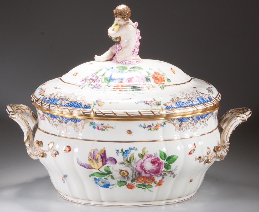 KPM BERLIN PORCELAIN LARGE SOUP TUREEN AND COVER: KPM BERLIN PORCELAIN LARGE SOUP TUREEN AND COVER, in Rococo style, with lobed and gently-ribbed sides, the domed cover topped by the fully-realized figure of a kneeling boy holding a squash, wearing c