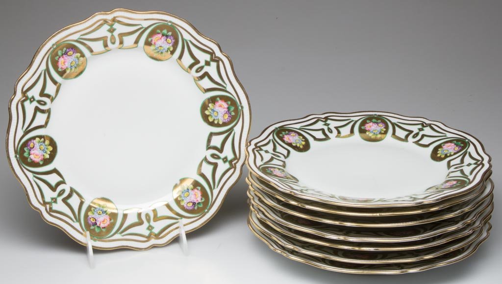 OSCAR AND EDGAR GUTHERZ, ALT-KOHLAW AUSTRIA EIGHT: OSCAR AND EDGAR GUTHERZ, ALT-KOHLAW AUSTRIA EIGHT DINNER PLATES, with lobed, shaped rims, the ridge-molded border under gilt bands, the shoulders painted with floral bouquets within ovular gilt cartou