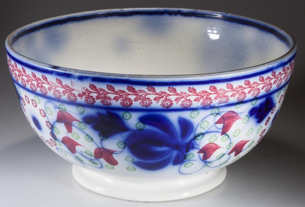 BRITISH GAUDY IRONSTONE PUNCH BOWL, FLOW BLUE AND: BRITISH GAUDY IRONSTONE PUNCH BOWL, FLOW BLUE AND STICK-SPATTER DECORATION, flow blue and stick-spatter decoration, wide band of cobalt blue underglaze flowers and curling lines, red and green flowerh