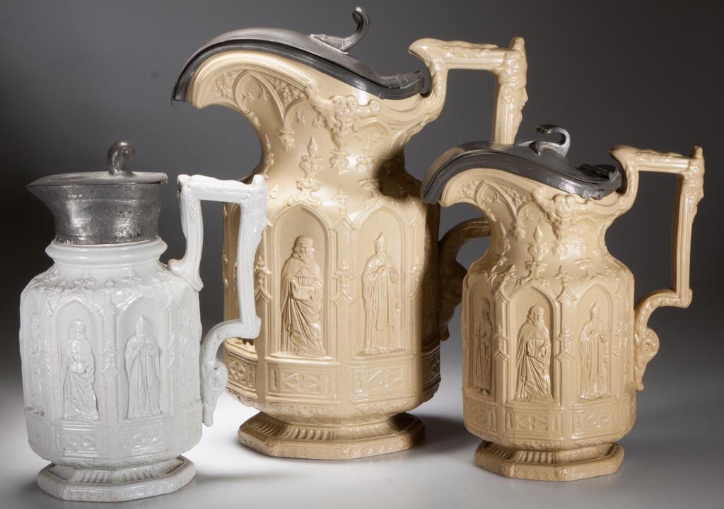 ENGLISH CHARLES MEIGH "APOSTLE" PITCHERS, LOT OF THREE: ENGLISH CHARLES MEIGH "APOSTLE" PITCHERS, LOT OF THREE, comprising two buff-colored and one white syrup, each molded in low relief with panels of the apostles to the waist, under neo-gothic motifs, sa