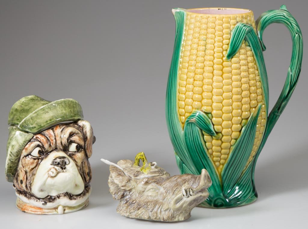 ASSORTED FIGURAL CERAMIC ARTICLES, LOT OF THREE: ASSORTED FIGURAL CERAMIC ARTICLES, LOT OF THREE, comprising a majolica corn pitcher with English registry mark, a majolica dog's head humidor, and a boar's head mustard pot with ladle, inscribed "37" 