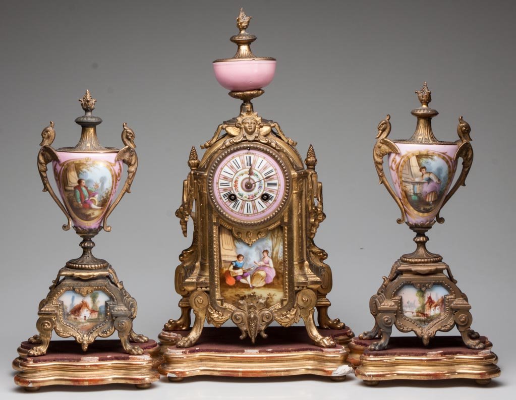 FRENCH GILT-METAL AND PORCELAIN CLOCK GARNITURE, THREE: FRENCH GILT-METAL AND PORCELAIN CLOCK GARNITURE, THREE PIECE SET, hand-painted porcelain inserts in the manner of Sevres, porcelain dial inscribed "Hry Marc Paris", movement markings include Paris, ot