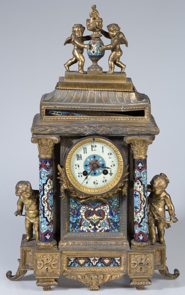 FRENCH GILT-METAL AND CHAMPLEVÉ ENAMEL FIGURAL SHELF CL: FRENCH GILT-METAL AND CHAMPLEVÉ ENAMEL FIGURAL SHELF CLOCK, mounted with four putti figures and columns, porcelain dial with enamel center, movement marked Medalille D'Argent and G. Megnin. Late 19th