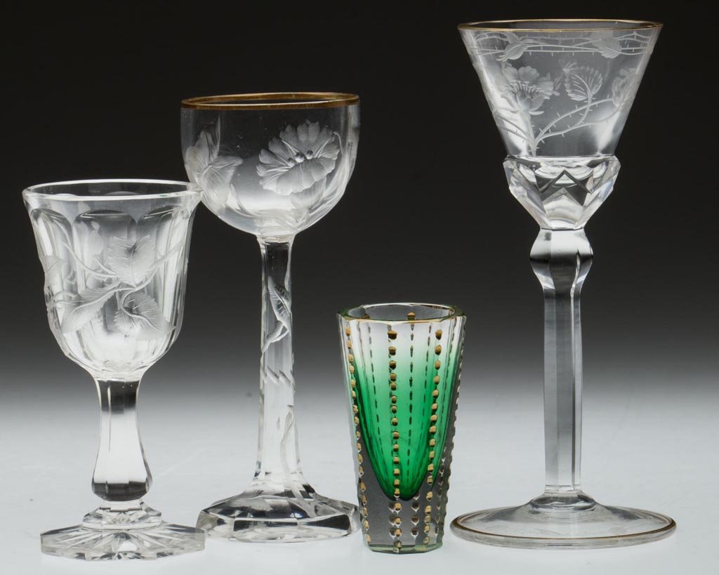 BOHEMIAN MOSER-STYLE ENGRAVED / CUT DRINKING VESSELS,: BOHEMIAN MOSER-STYLE ENGRAVED / CUT DRINKING VESSELS, LOT OF FOUR, one shaded green and remaining colorless, each with gilding, comprising three wines/cordials and one shot glass, decorations include 