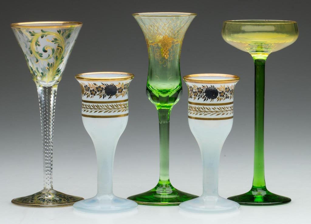ASSORTED GLASS WINES / CORDIALS, LOT OF FIVE: ASSORTED GLASS WINES / CORDIALS, LOT OF FIVE, including a pair of opaline with gilt and silver decorations and a trumpet-form example with delicate green scrolls. France, Austria and others. Mid 19th