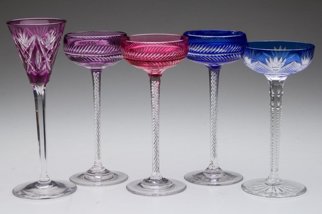 CONTINENTAL CUT-OVERLAY TALL-STEM CORDIALS / LIQUOR: CONTINENTAL CUT-OVERLAY TALL-STEM CORDIALS / LIQUOR GLASSES, LOT OF FIVE, ruby, amethyst, and blue to colorless, comprising four with saucer-shape bowl, three of which are raised on an air-twist stem,
