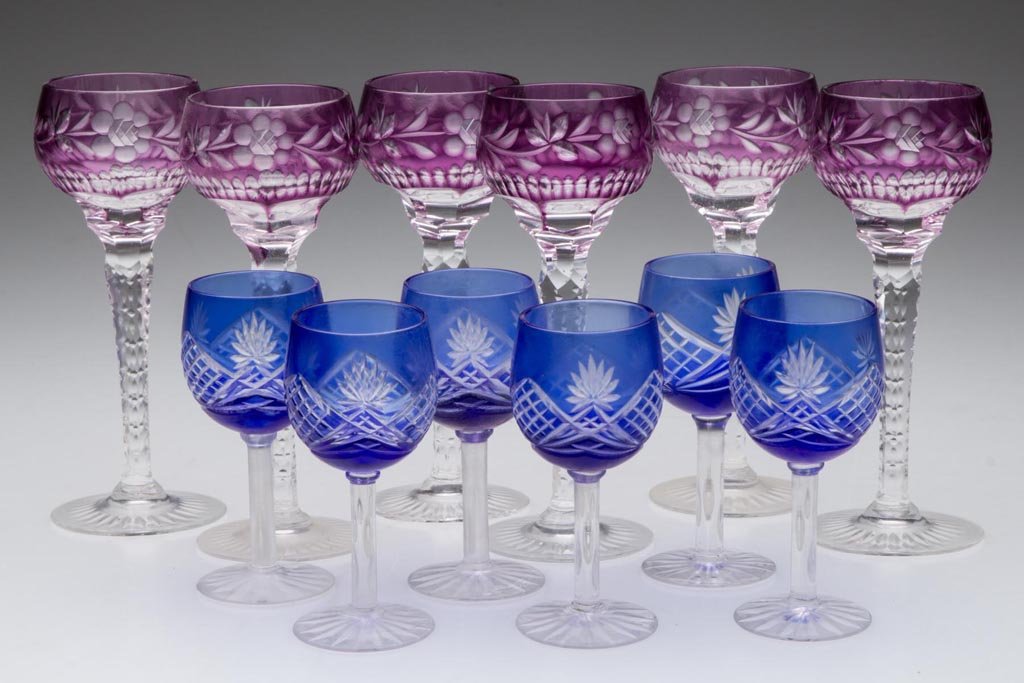ASSORTED CUT-OVERLAY CORDIALS / LIQUOR GLASSES, LOT OF: ASSORTED CUT-OVERLAY CORDIALS / LIQUOR GLASSES, LOT OF 12, amethyst and cobalt blue to colorless, comprising two sets of six, one set raised on tall notched stems. 20th century. 3 1/4" to 5" H. Proven
