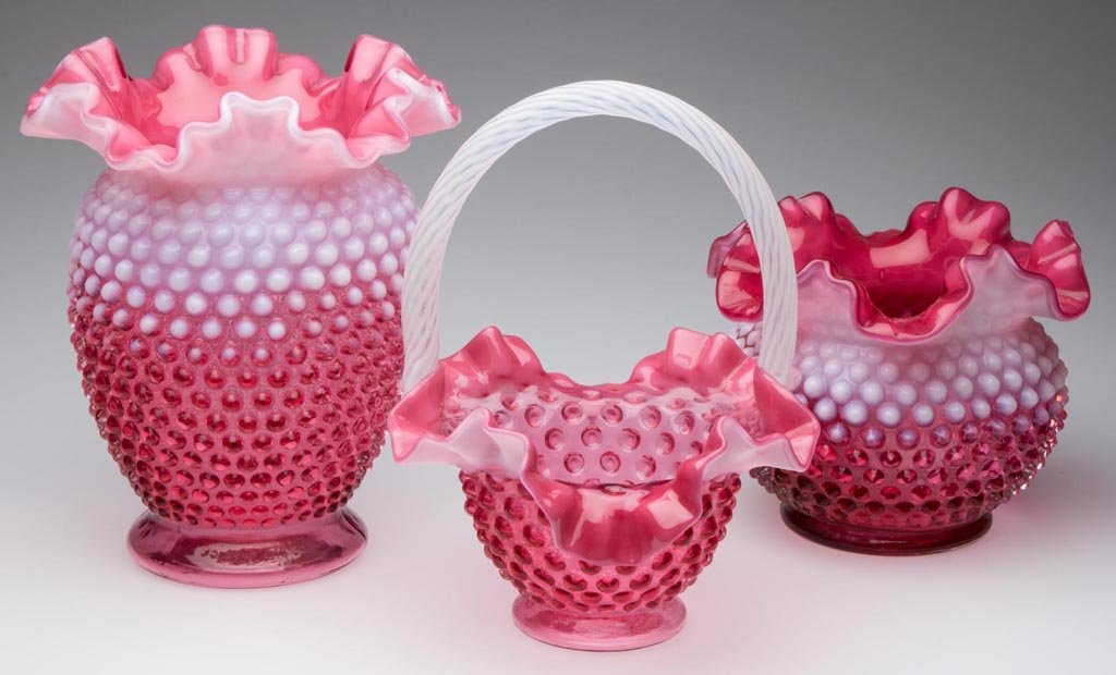 FENTON HOBNAIL ARTICLES, LOT OF THREE: FENTON HOBNAIL ARTICLES, LOT OF THREE, cranberry opalescent, comprising a basket, tall vase, and squat vase, two with embossed trademark in base. Fenton Art Glass Co. 20th century. 5" to 7 3/4" H.