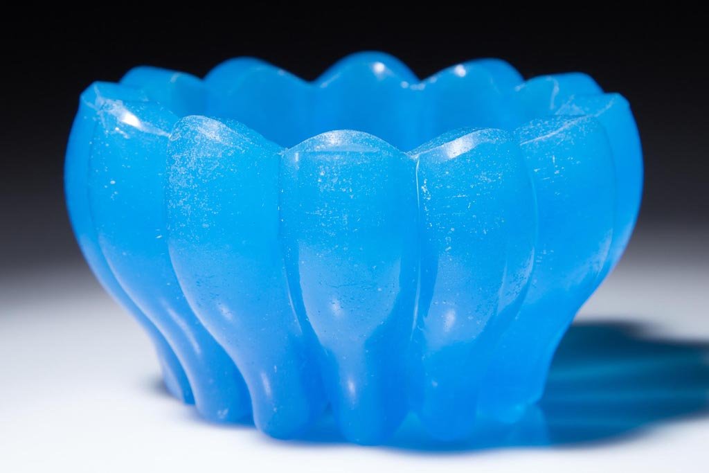 HEAVY RIBBED PRESSED OPEN SALT: HEAVY RIBBED PRESSED OPEN SALT, translucent starch blue, circular form with 12 vertical ribs. 1840-1860. 1 3/4" H, 3 1/8" D. Provenance: From the Greg & Joyce Prus collection of Plantsville, CT. Colle