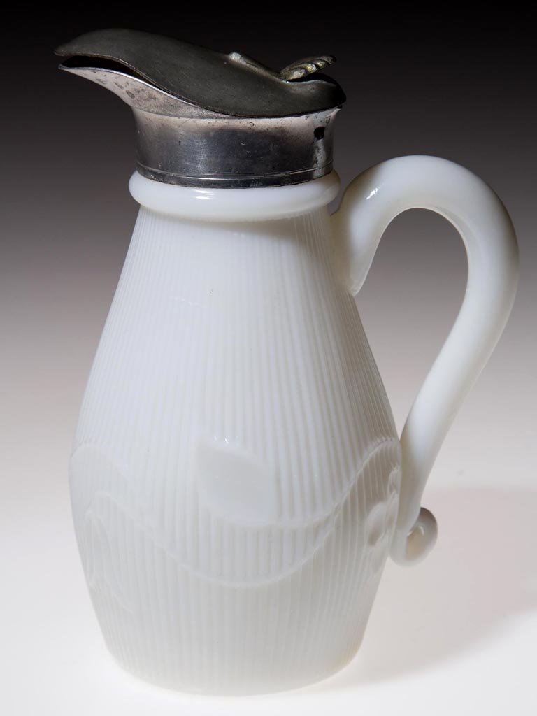 BELLFLOWER - SINGLE VINE MOLASSES JUG / SYRUP: BELLFLOWER - SINGLE VINE MOLASSES JUG / SYRUP, opaque white, small-size ovoid body with vine flowing left, applied solid handle, and plain base. Period Britannia hinged lid without markings. Probably 