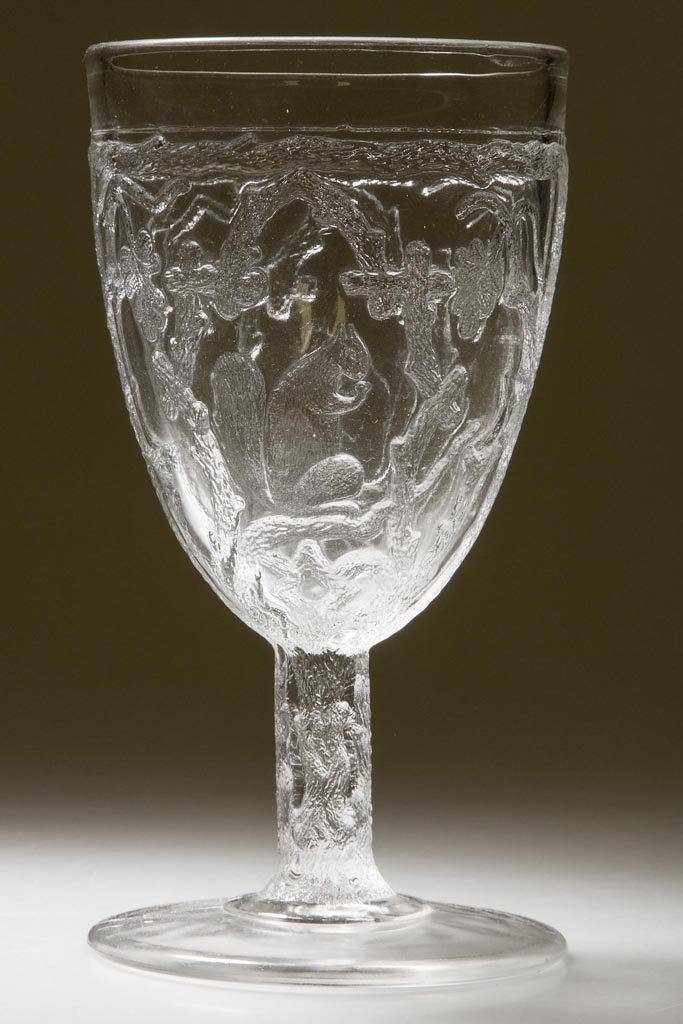 SQUIRREL GOBLET: SQUIRREL GOBLET, colorless, standard version with a flare and step at base of stem. Fourth quarter 19th century. 5 7/8" H. Provenance: Personal collection of Judith (Judy) Cronin, Orleans, MA.