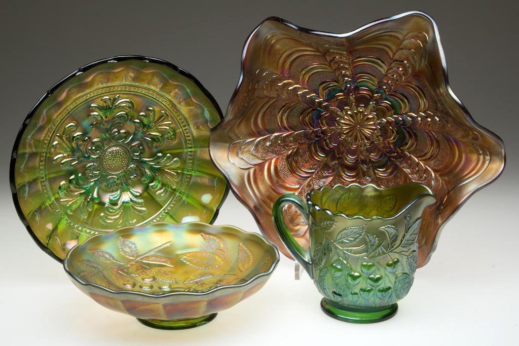 ASSORTED MILLERSBURG CARNIVAL GLASS ARTICLES, LOT OF: ASSORTED MILLERSBURG CARNIVAL GLASS ARTICLES, LOT OF FOUR, amethyst and green, comprising a Hanging Cherries bowl and creamer, a Mayan bowl, and a Rosalind bowl. Millersburg Glass Co. First quarter 20
