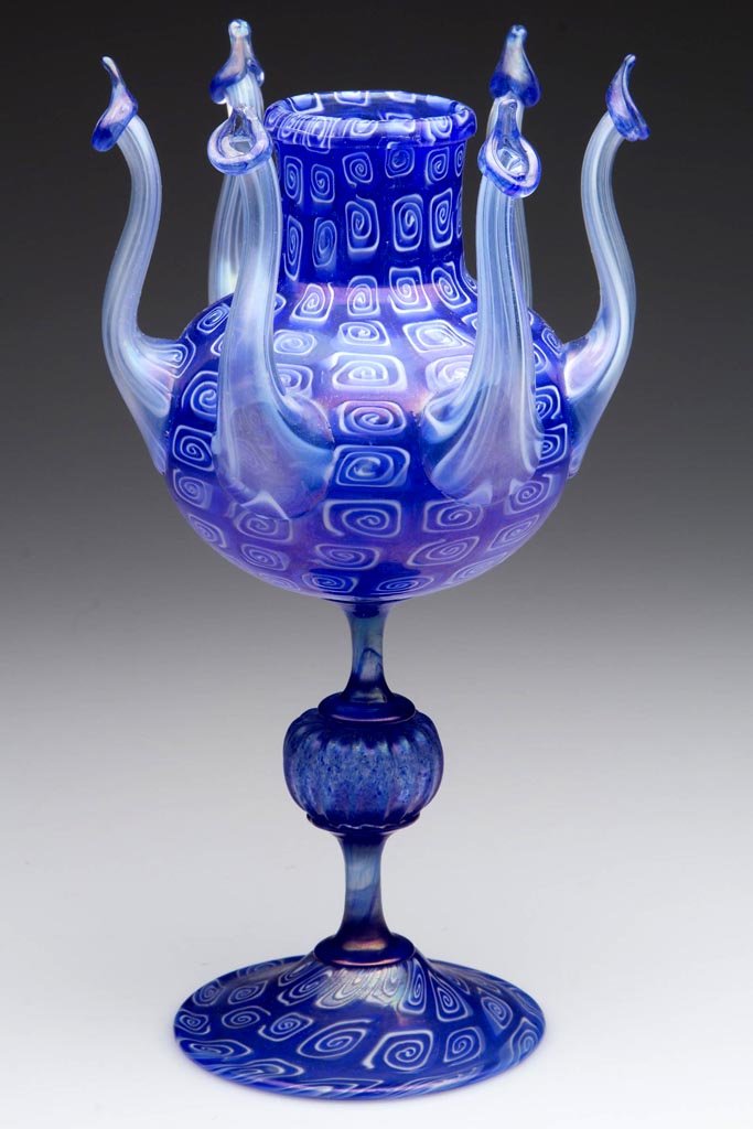 ITALIAN MURRINE DECORATED OCTOPUS-FORM VASE: ITALIAN MURRINE DECORATED OCTOPUS-FORM VASE, iridescent blue with white squared swirls, vase with six arms emanating upward from the lower bowl, raised on a delicate stem with medial ribbed knop and a