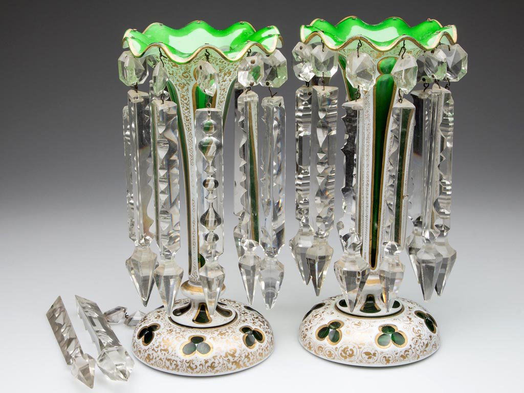 CUT OVERLAY MOORISH WINDOWS PAIR OF MANTLE LUSTERS: CUT OVERLAY MOORISH WINDOWS PAIR OF MANTLE LUSTERS, white to medium green with gilt decorations, each gauffered-rim trumpet-form vase hung with ten fancy-cut prisms, the whole raised on a domed foot.