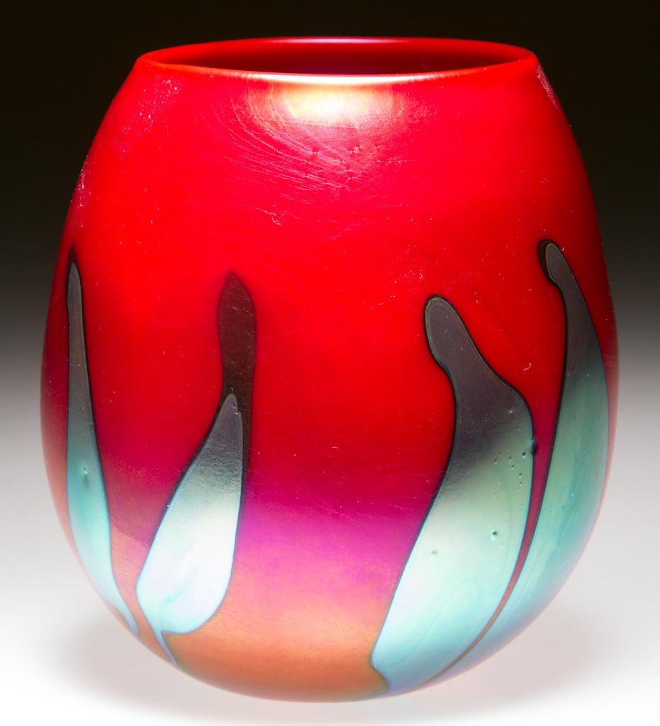CHARLES LOTTON STUDIO ART GLASS VASE: CHARLES LOTTON STUDIO ART GLASS VASE, opaque mandarin red iridescent, egg form with blue iridescent split-leaf decoration, signed "Charles Lotton 2007" under the base. 3 3/4" H. Provenance: From the c