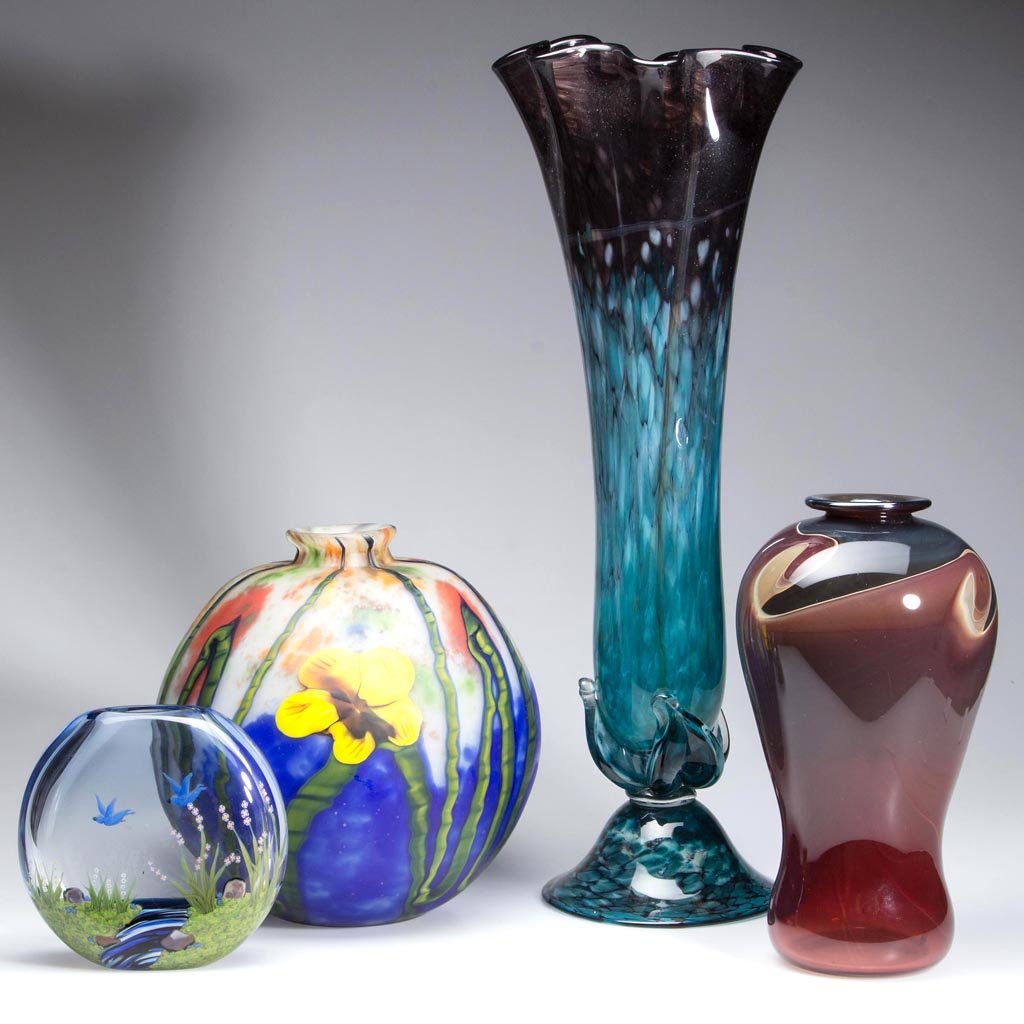 ASSORTED STUDIO ART GLASS VASES, LOT OF FOUR: ASSORTED STUDIO ART GLASS VASES, LOT OF FOUR, including pillow vase with flowers and birds singed by J. Todd Yaffa, 1991, and a swirled brown and black vase signed by Daniel Reed. 20th and 21st centur