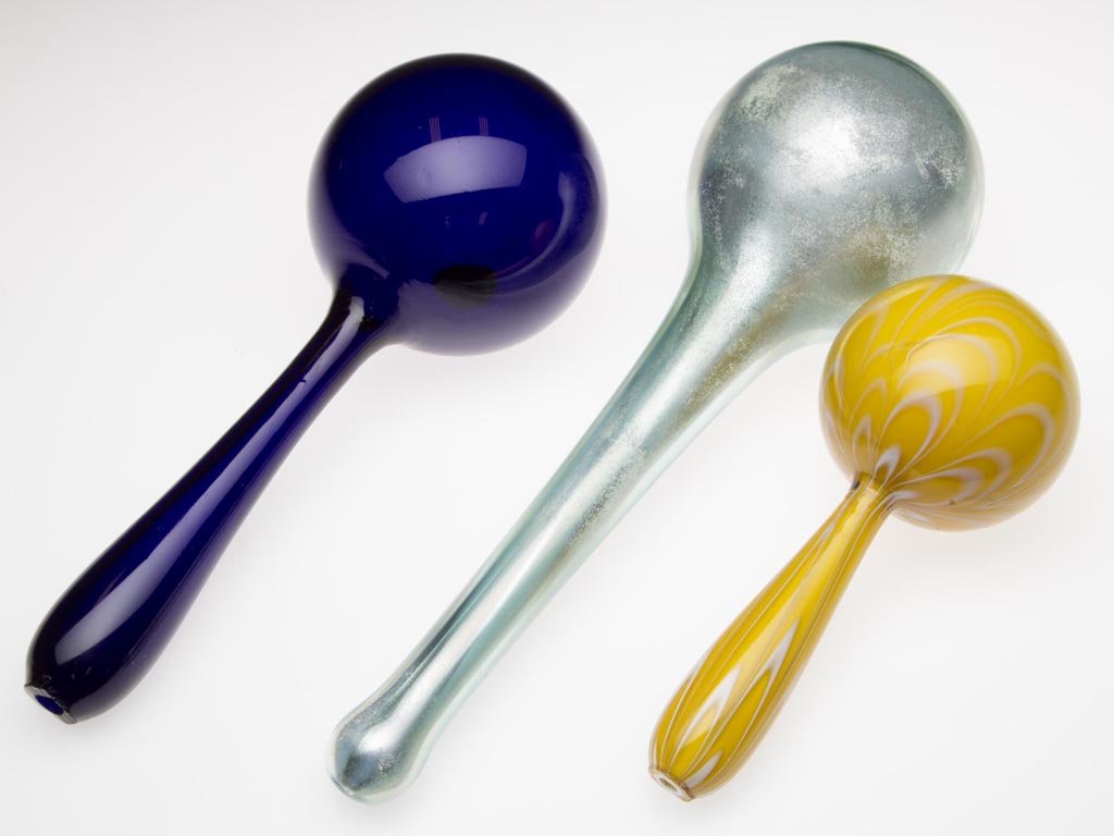 FREE-BLOWN GLASS DARNING BALLS, LOT OF THREE: FREE-BLOWN GLASS DARNING BALLS, LOT OF THREE, comprising an opal-cased yellow example with opal marbrie loops, and a cobalt blue example, each with rough, open-pontil end handle, along with an aqua ex