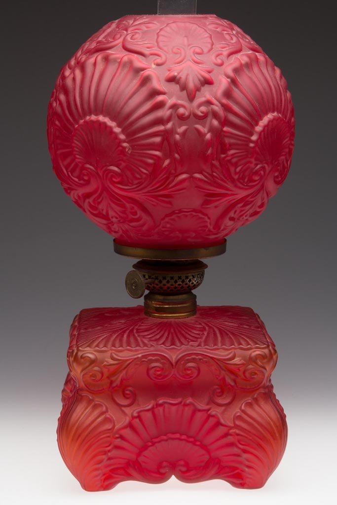 SMITH II, FIG. 404 / MOLDED SATIN GLASS JUNIOR PARLOR: SMITH II, FIG. 404 / MOLDED SATIN GLASS JUNIOR PARLOR LAMP, ruby, matching patterned ball shade, embossed pattern of shells, period No. 1 Taplin-Brown collar. Fitted with a period Plume & Atwood Victo