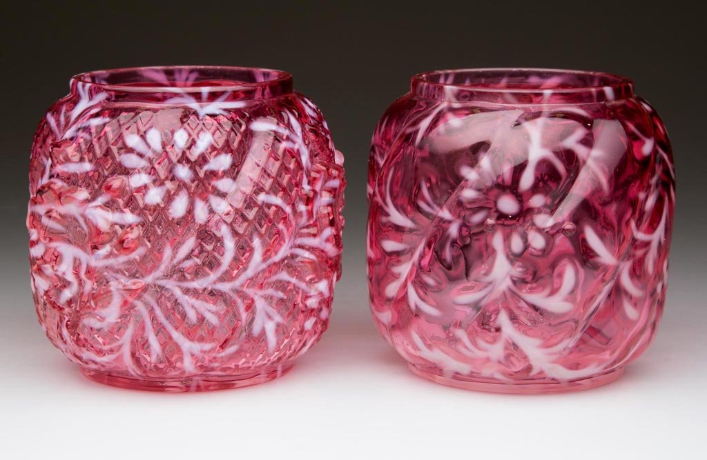DAISY AND FERN PICKLE CASTER INSERTS, LOT OF TWO: DAISY AND FERN PICKLE CASTER INSERTS, LOT OF TWO, cranberry opalescent, comprising a Northwood Swirl mold and an Apple Blossom Mold, each with factory polished rim. Northwood Glass Co. Circa 1894. 3 1
