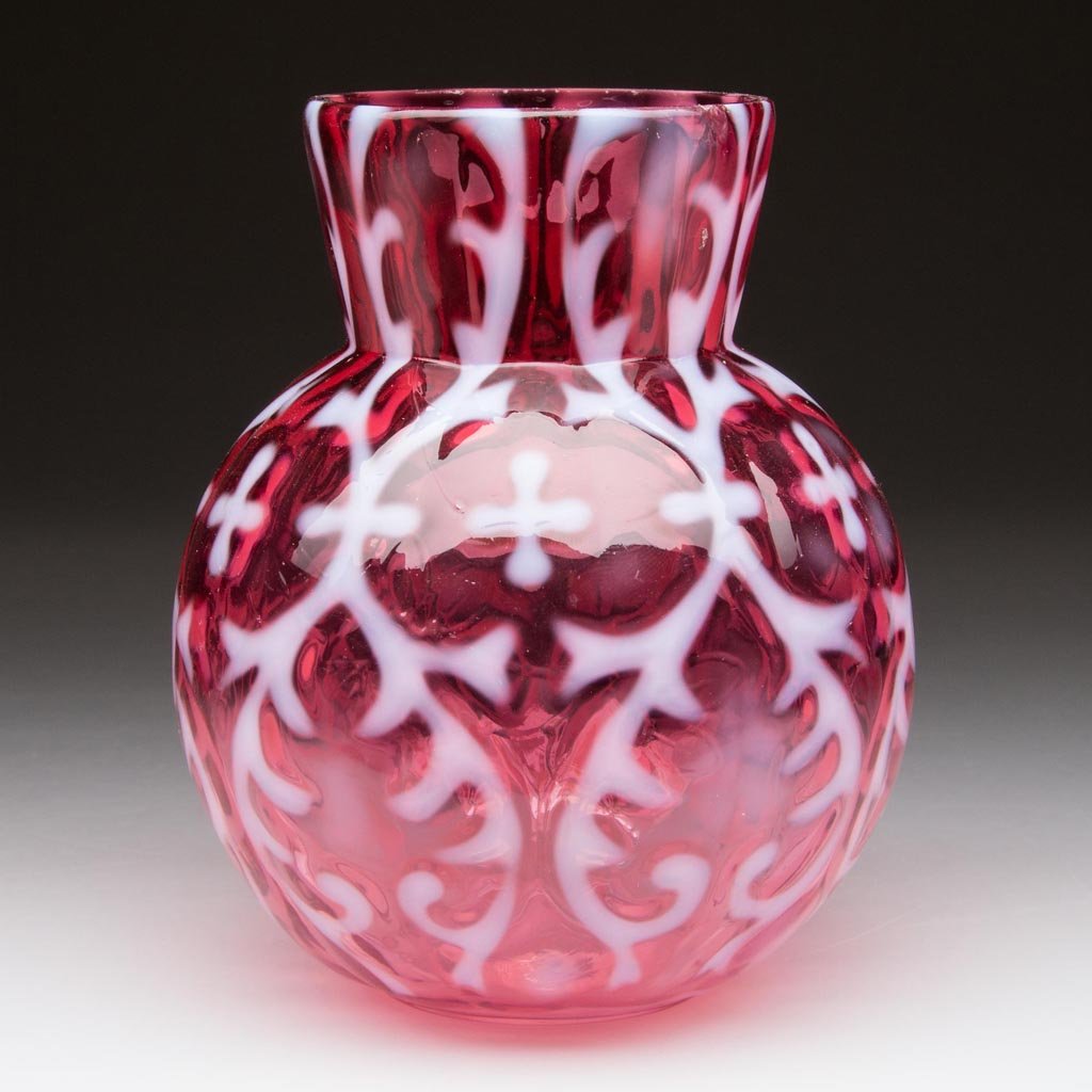 OPALINE BROCADE / SPANISH LACE VASE: OPALINE BROCADE / SPANISH LACE VASE, cranberry opalescent, with light melon-form body with a vine flowing to the left and slightly flared rim. Northwood Glass Co. Circa 1899. 4 1/4" H. Provenance: Fro