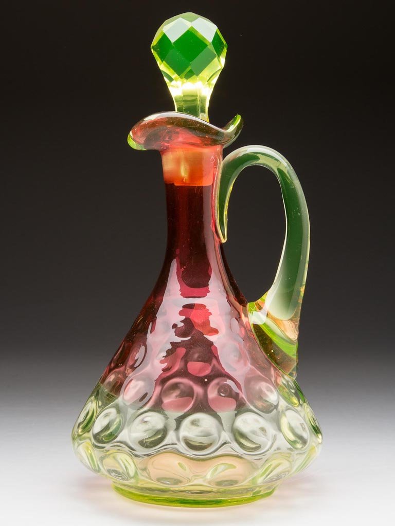 HOBBS NO. 308 / POLKA DOT CRUET: HOBBS NO. 308 / POLKA DOT CRUET, Rubina verde (uranium), skirted form with triangular-form rim, canary applied handle and facet-cut stopper, polished pontil mark. Hobbs, Brockunier & Co. Circa 1884. 7