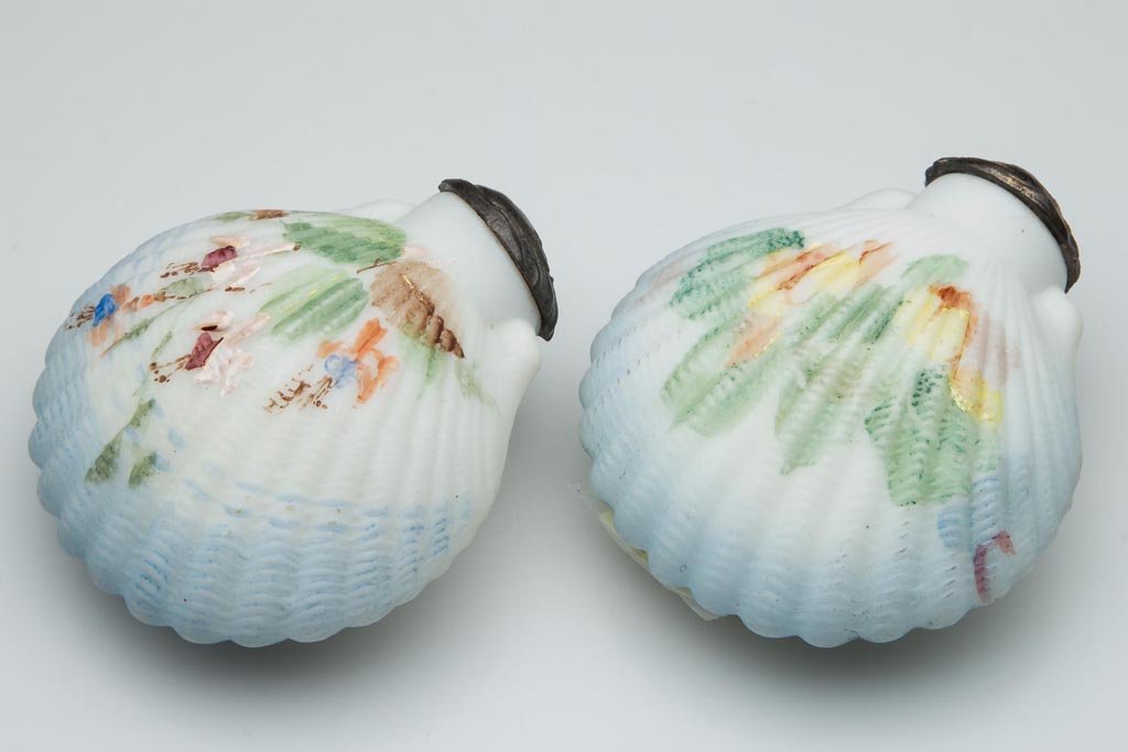 MT. WASHINGTON COCKLESHELL NEAR PAIR OF SALT AND PEPPER: MT. WASHINGTON COCKLESHELL NEAR PAIR OF SALT AND PEPPER SHAKERS, opaque white with pale blue shading, plush/satin finish, each with polychrome floral decoration and matching period lids. Mt. Washingto