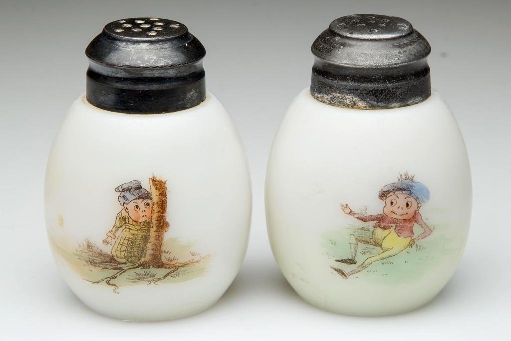 MT. WASHINGTON EGG - PALMER COX BROWNIE PAIR OF SALT: MT. WASHINGTON EGG - PALMER COX BROWNIE PAIR OF SALT AND PEPPER SHAKERS, opal, glossy finish, each with transfer decoration on front and reverse, matching period lids. Mt. Washington Glass Co. Fourth 