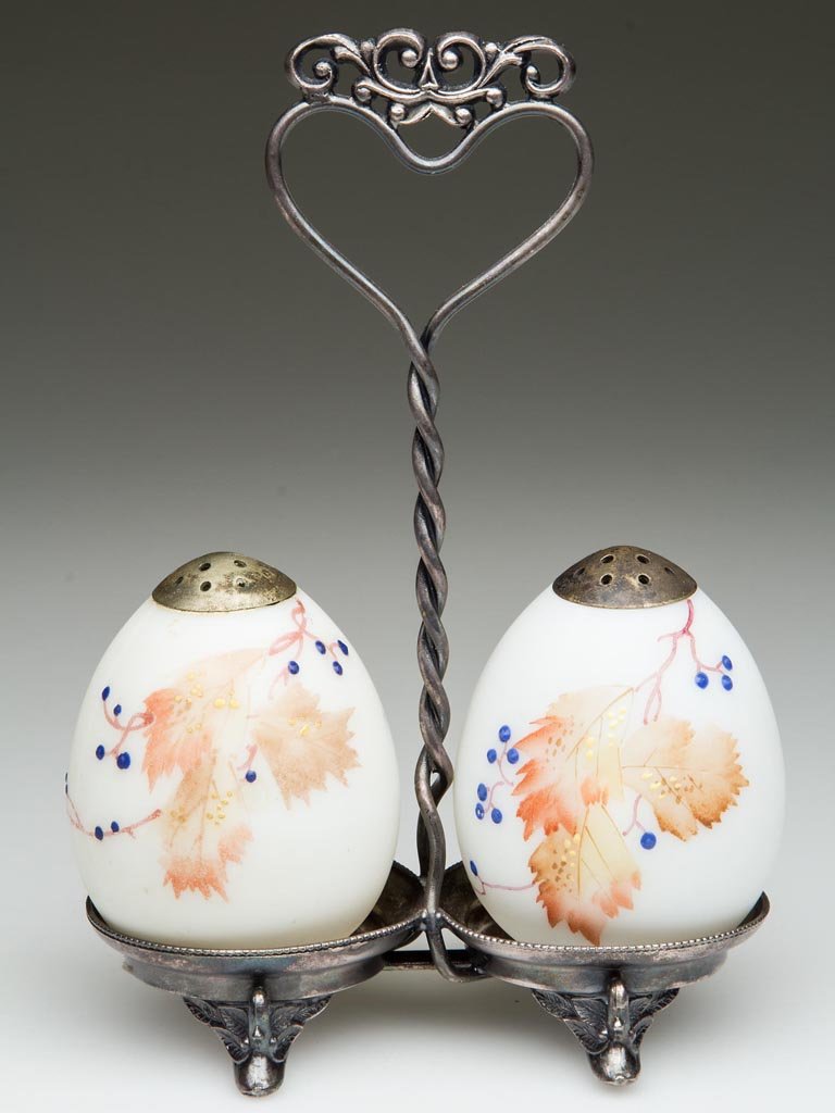 MT. WASHINGTON OSTRICH EGG PAIR OF SALT AND PEPPER: MT. WASHINGTON OSTRICH EGG PAIR OF SALT AND PEPPER SHAKERS, opal, plush/satin finish, with polychrome autumn and berry decoration and matching, period lids. Fitted in a quadruple-plate stand marked fo