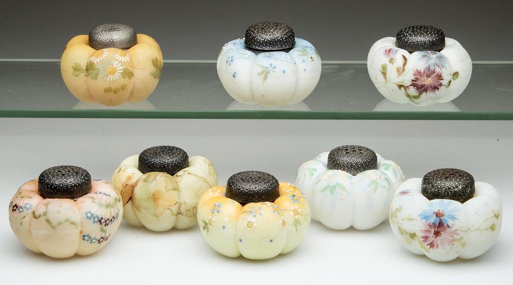 MT. WASHINGTON TOMATO SALT SHAKERS, LOT OF EIGHT: MT. WASHINGTON TOMATO SALT SHAKERS, LOT OF EIGHT, opal, plush/satin finish, each with polychrome floral decoration, with period, two-part lids. Mt. Washington Glass Co. Fourth quarter 19th century. 1 