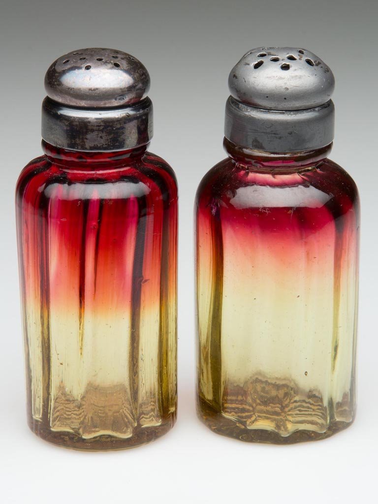 DUAL-MOLD AMBERINA PAIR OF SALT AND PEPPER SHAKERS: DUAL-MOLD AMBERINA PAIR OF SALT AND PEPPER SHAKERS, with matching, period two-part lids. Fourth quarter 19th century. 3 3/4" HOA. Provenance: The collection of the late Richard "Dick" and Mary Ann Kra