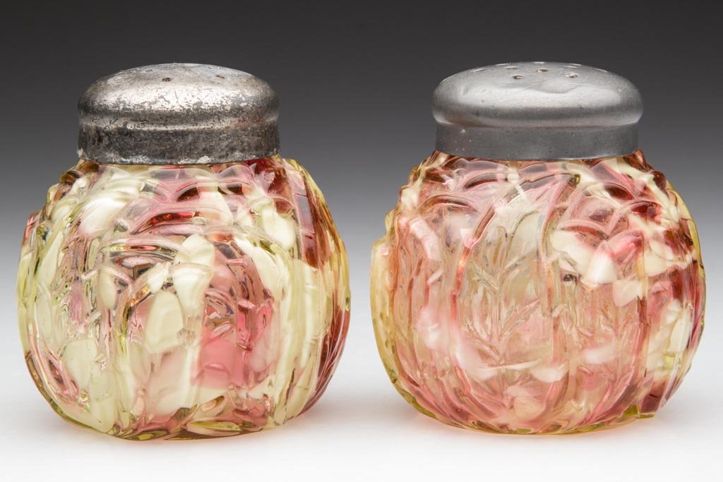 NORTHWOOD NO. 333 / LEAF MOLD SALT AND PEPPER SHAKERS,: NORTHWOOD NO. 333 / LEAF MOLD SALT AND PEPPER SHAKERS, LOT OF TWO, canary/vaseline (uranium) with cranberry and opal spatter, with period lids. Northwood Glass Co. Pattern introduced in 1891. 2 5/8" H