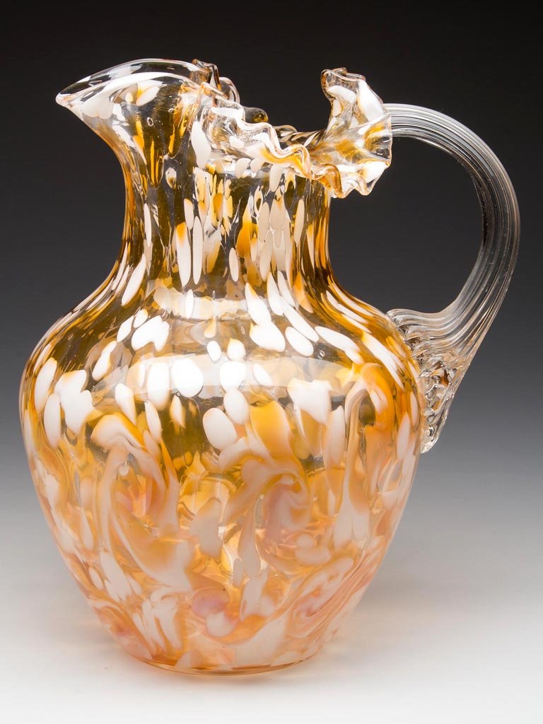 PHOENIX SPOT-OPTIC SPATTER WATER PITCHER: PHOENIX SPOT-OPTIC SPATTER WATER PITCHER, colorless with opal and apricot flakes, shouldered form with crimped top, U-shape spout, applied colorless reeded handle, and polished pontil mark. Phoenix Gl