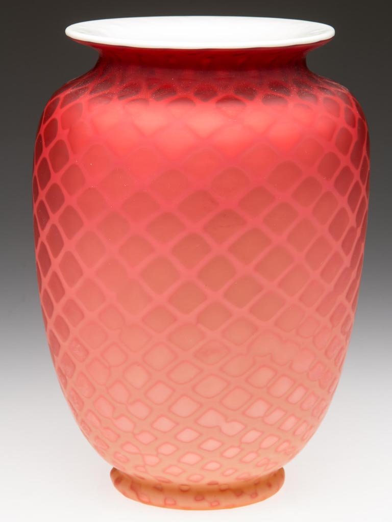 DIAMOND QUILT AIR-TRAP MOTHER-OF-PEARL SATIN GLASS VASE: DIAMOND QUILT AIR-TRAP MOTHER-OF-PEARL SATIN GLASS VASE, shaded vermillion with creamy white interior casing, urn-form with flared rim and slight foot, polished pontil mark. Probably Thomas Webb & Son