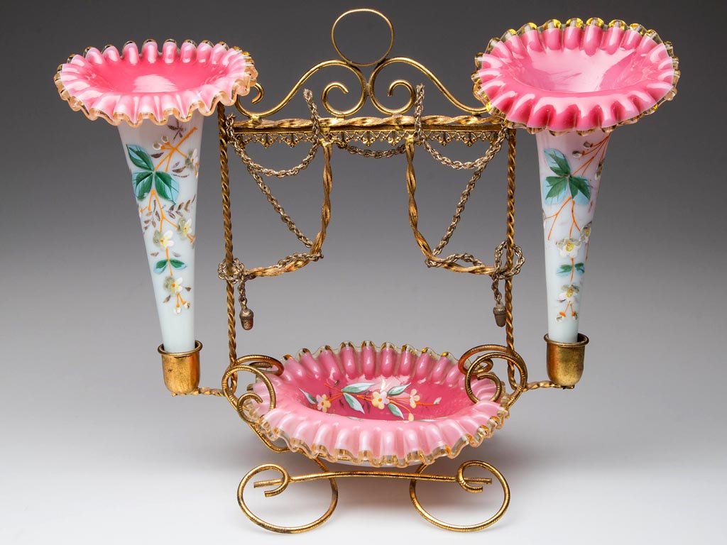VICTORIAN CASED GLASS DRESSER EPERGNE: VICTORIAN CASED GLASS DRESSER EPERGNE, rose and opal, comprising two Jack-in-the-Pulpit vases and a matching pin tray, each with applied amber rim and polychrome-enamel floral decoration, fitted in an