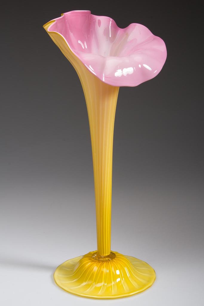 CASED PILLAR-MOLDED GLASS JACK-IN-THE-PULPIT VASE: CASED PILLAR-MOLDED GLASS JACK-IN-THE-PULPIT VASE, rose-cased yellow, patterned with 18 ribs, raised on a matching applied domed foot with folded rim and rough pontil mark. 20th century. 14 1/2" H. Pr
