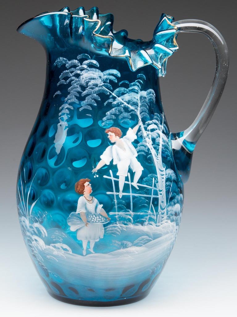 MARY GREGORY (SO CALLED) DOT- / SPOT-OPTIC WATER: MARY GREGORY (SO CALLED) DOT- / SPOT-OPTIC WATER PITCHER, blue with worn gilt-decorated rim, with polychrome decoration depicting a boy and girl picking cherries, folded and crimped rim, colorless app