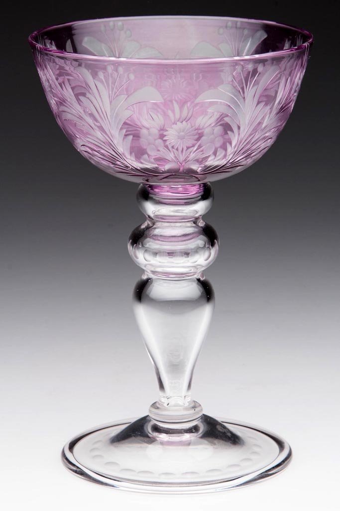 STEUBEN "HARVARD" ENGRAVED OVERLAY CHAMPAGNE GLASS: STEUBEN "HARVARD" ENGRAVED OVERLAY CHAMPAGNE GLASS, amethyst to colorless, shape 6505, colorless hollow stem and slightly domed foot with folded edge, small polished pontil mark, Fleur-de-lis acid-sta