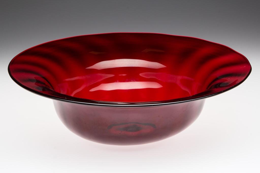 STEUBEN STYLE RIB-OPTIC CENTERPIECE BOWL: STEUBEN STYLE RIB-OPTIC CENTERPIECE BOWL, deep ruby, possibly Selenium Red, high lead content, polished pontil mark. First quarter 20th century. 3 1/2" H, 12" D. Provenance: From a New Jersey private 