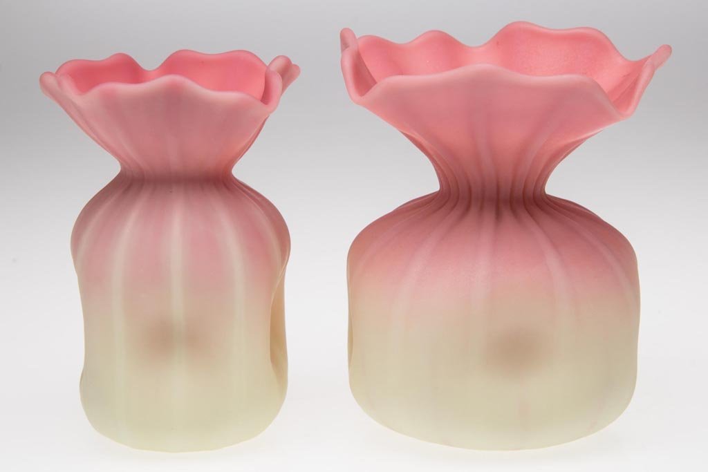 WEBB BURMESE CABINET VASES, LOT OF TWO: WEBB BURMESE CABINET VASES, LOT OF TWO, plush finish, undecorated, each rib-molded bag-like form with pinched sides and polished pontil mark. Thomas Webb & Sons. Circa 1886-1895. 3 1/2" H. Provenance: