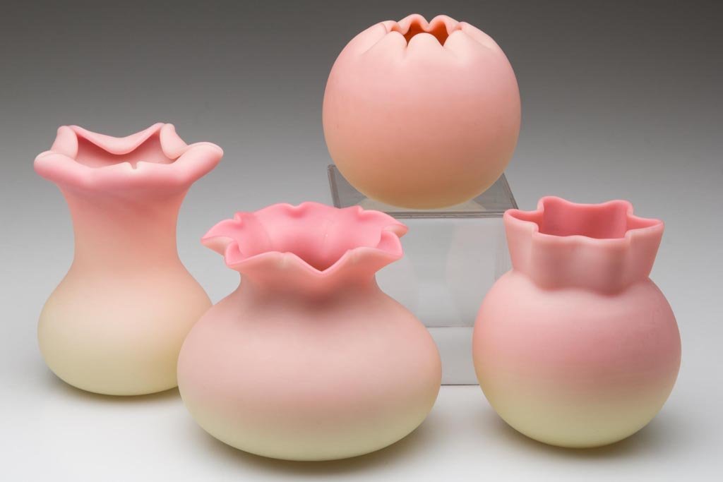 WEBB BURMESE CABINET VASES, LOT OF FOUR: WEBB BURMESE CABINET VASES, LOT OF FOUR, plush finish, undecorated, various crimped and folded rims, each with polished pontil mark. Thomas Webb & Sons. Circa 1886-1895. 2 1/4" to 3 1/4" H. Provenance