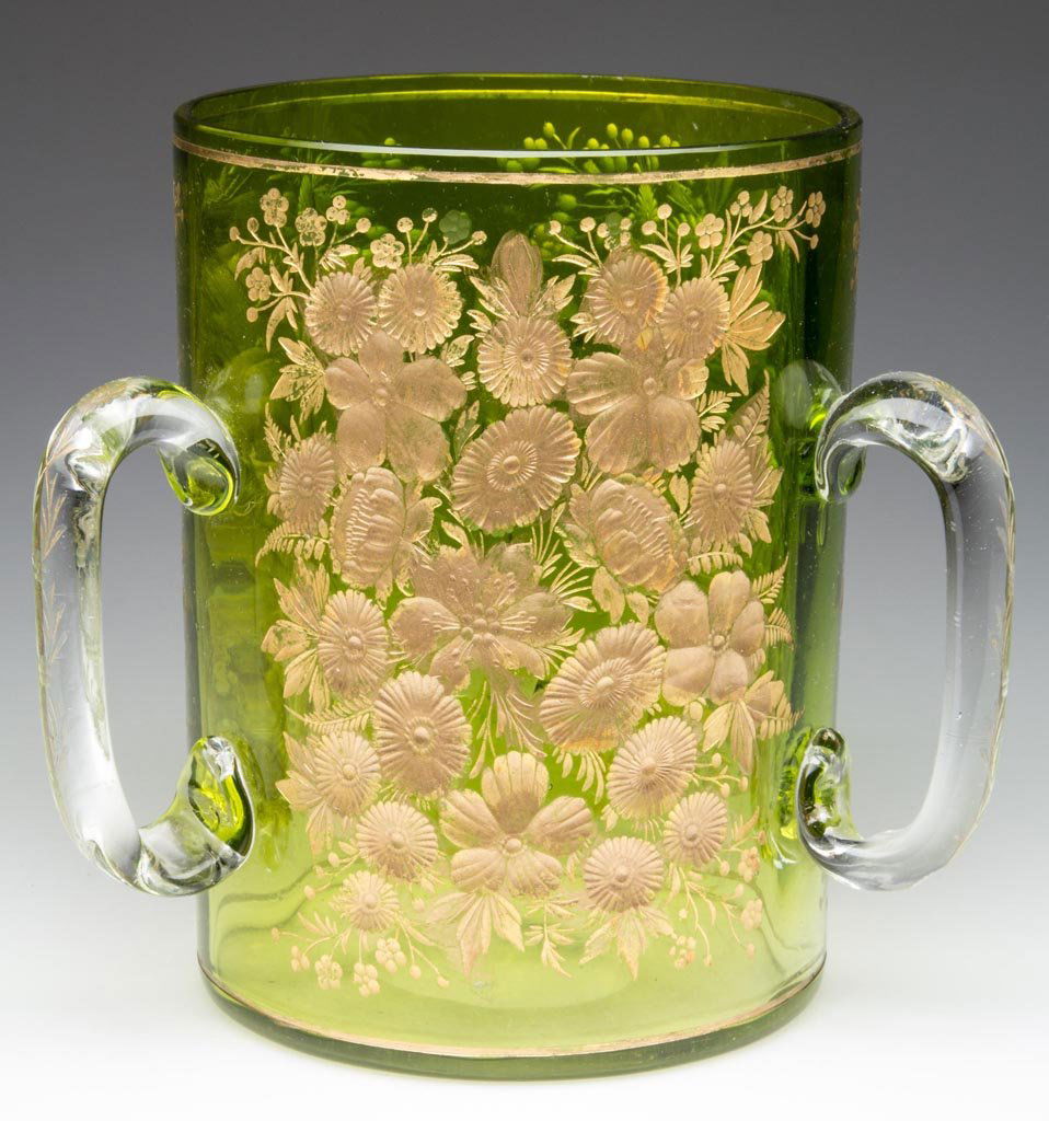MOSER INTAGLIO CUT LOVING CUP: MOSER INTAGLIO CUT LOVING CUP, shaded green, rib-optic cup with three panels of elaborate floral and gilt decorations, three colorless, applied handles also with cut decoration, polished base. Fourth