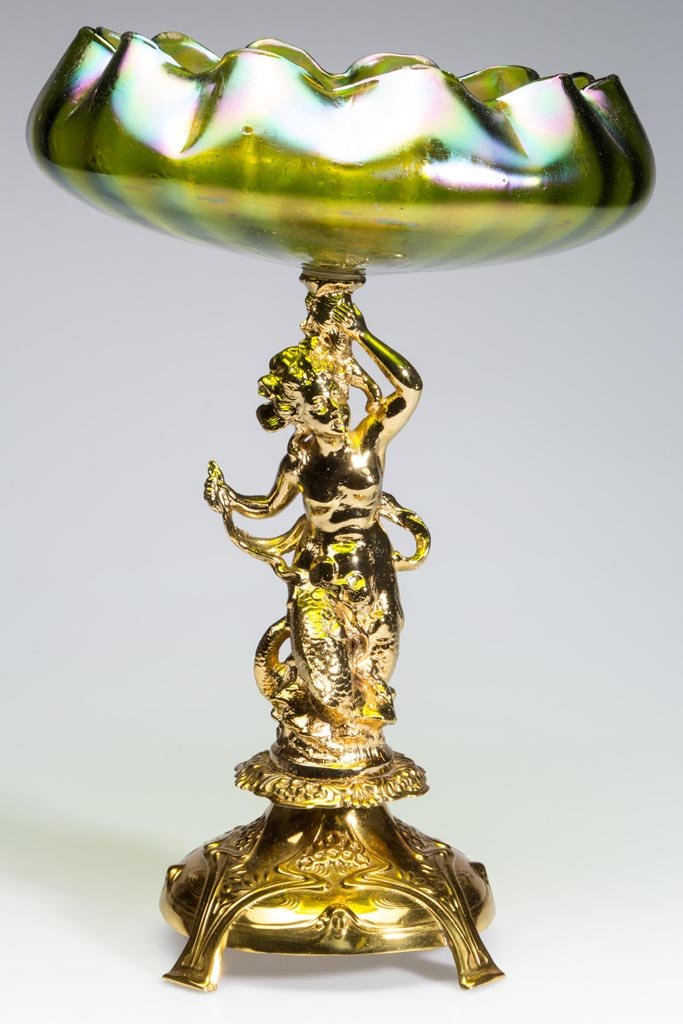 LOETZ-TYPE BOHEMIAN BRIDE'S / CENTERPIECE BOWL: LOETZ-TYPE BOHEMIAN BRIDE'S / CENTERPIECE BOWL, green iridescent, shallow rib-optic ruffled-rim form raised on a brass and brass-plated high standard depicting a mermaid resting on an Art Nouveau base
