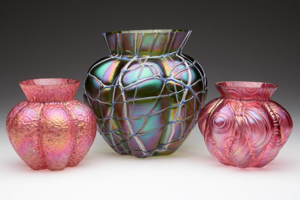LOETZ-TYPE BOHEMIAN VASES, LOT OF THREE: LOETZ-TYPE BOHEMIAN VASES, LOT OF THREE, crete and ruby iridescent, each melon-like form, one with applied random threading, others with molded pattern, each with factory polished rim and plain base.