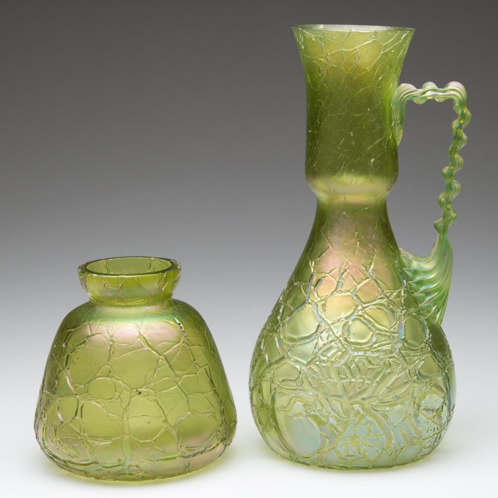 LOETZ-TYPE BOHEMIAN VASES, LOT OF TWO: LOETZ-TYPE BOHEMIAN VASES, LOT OF TWO, green iridescent, each Mimosa style with craquele surface, one with applied crimped and reeded handle, factory polished rims. Handled example with small etched "