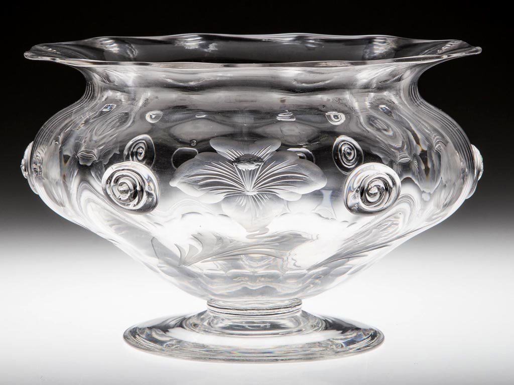 ENGRAVED AND DECORATED RIB-OPTIC FOOTED BOWL: ENGRAVED AND DECORATED RIB-OPTIC FOOTED BOWL, colorless lead glass, deeply engraved Art Nouveau flowers separated by applied spiral prunts, applied foot with a polished pontil mark. First quarter 20th