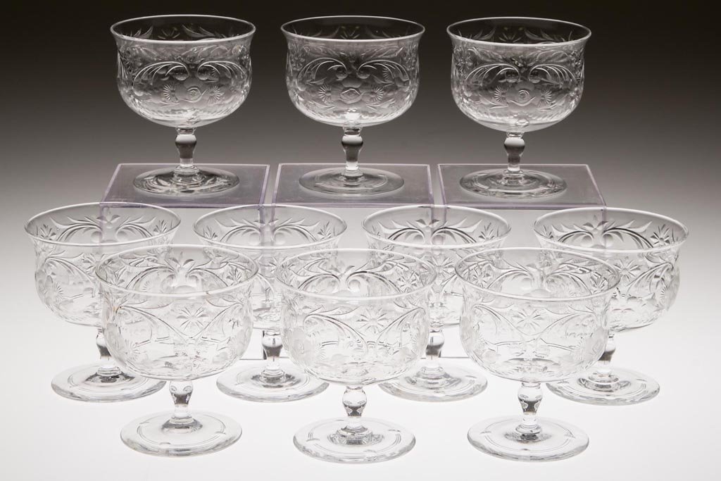 CORBETT WEBB ENGRAVED GLASS FOOTED SHERBETS, SET OF TEN: CORBETT WEBB ENGRAVED GLASS FOOTED SHERBETS, SET OF TEN, colorless, Rock-Crystal-type pattern, slightly flared rim, six examples signed to underside of foot. 20th century. 3 3/4" H, 3 3/8" D rim. Prov